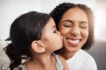 Canvas Print - Kiss, love and girl with mother on a sofa, happy and smile while bonding in their home together. Family, kisses and parent with child on a couch, bond and cheerful, loving and caring in a living room