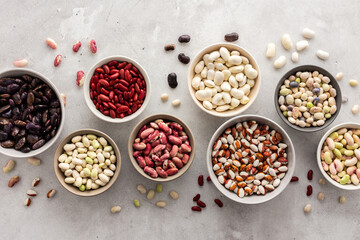 Different types of beans in bowls, economically important legume, top view, copy space