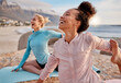 © Lumeez/peopleimages.com - Yoga, laugh and woman friends on the beach together for mental health, wellness or fun in summer. Exercise, diversity or nature with a female yogi and friend laughing or joking outside for humor