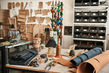 Tools and material sitting on a leather studio workbench
