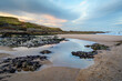 Tidal Pool at Cocklawburn Beach near sunset, located in north Northumberland, Saltpan Rocks consist of limestone, sandstone, shales and thin coals deposited 330 M years ago in carboniferous times