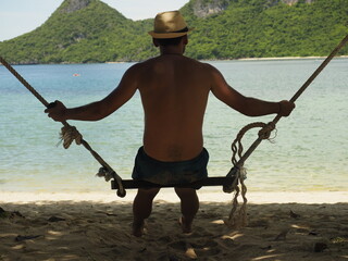 young man laying in a thailand beach