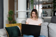 © Srdjan - Young business woman home interior designer working on her laptop for new client who bought apartment and want improvement. Female Feng Shui expert looking on her computer design of furniture