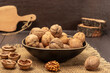 © 201122 - Walnuts in a bowl. Walnut shells and kernel on a burlap cloth.