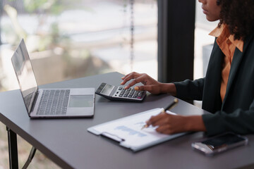 Wall Mural - Accountant black woman working on laptop and do document, tax, exchange, accounting and Financial advisor concept