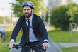 Cheerful manager wearing business apparel commuting to work on bike lane.