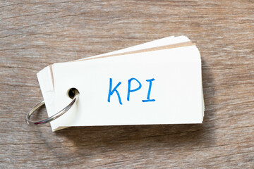 Poster - Flash card with handwriting in word KPI (Abbreviation of key performance indicator) on wood background