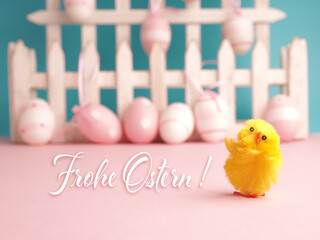  Cute chick with the German words Happy Easter and pink Easter eggs in the background