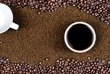 Fototapeta Paryż - Top view of a coffee cup on a textured brown background with roasted coffee beans. Ai-generated decorative design illustration.