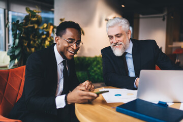 Multiracial colleagues smiling while working