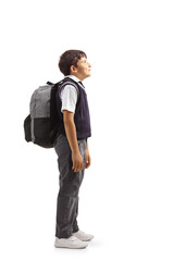 Poster - Full length profile shot of a boy in a school uniform carrying a backpack and looking up