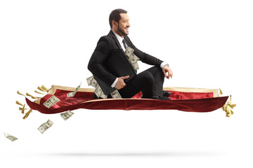 Sticker - Businessman holding a suitcase with money and sitting on a flying carpet