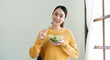 © Natee Meepian - Delighted woman eating food for health at home