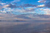 Fototapeta Nowy Jork - Scenic view of beautiful water reflections in lake of Bonneville Salt Flats at sunset, Wendover, Western Utah, USA, America. Dreamy clouds mirroring on the water surface creating romantic atmosphere