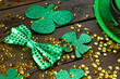 Image of green hat, clover and copy space on wooden background