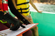 Marine biologist pointing to a data paper on a boat