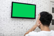 © Vitaliy - Shocked man on the couch watching tv. Bad news and Green screen concept