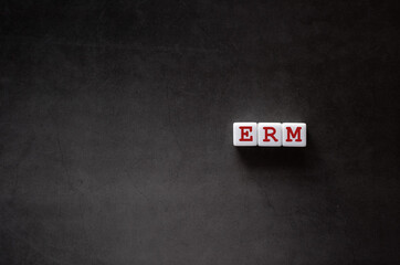 Poster - There is white cube with the word ERM. It is an abbreviation for Enterprise Risk Management as eye-catching image.