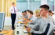 © JackF - Group of teenage students using smartphones in classroom at school