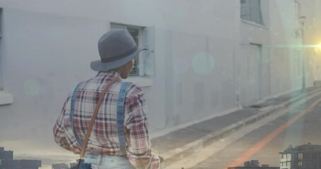Poster - Animation of light spots over biracial woman using scooter on street