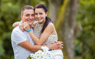 Happy young couple in love outdoors in park