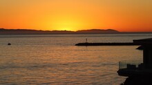 Beautiful Mellow Sunset Over Catalina Island In Orange County, California. Beautiful Sunset Background Image Golden Hour. Exotic Destination For Vacation Or Travel Background Image For Web Design.