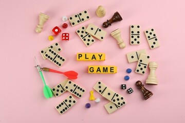 Wall Mural - Flat lay composition of blocks with words Play Game on pink background