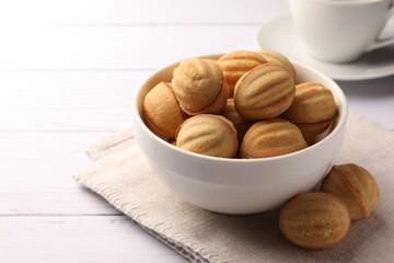 Delicious nut shaped cookies with boiled condensed milk on white wooden table