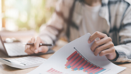 Poster - Businessman calculating figures in company financial documents with a calculator, analysis of company financial data, Planning to assess and review budgets, concept of financial growth and investment