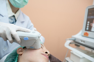 Wall Mural - Beautician procedure by electric device,Ultrasound therapy treatment for skin tightening in aesthetic clinic.