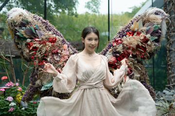 Wall Mural - Woman walk in beautiful flower exhibition indoor.