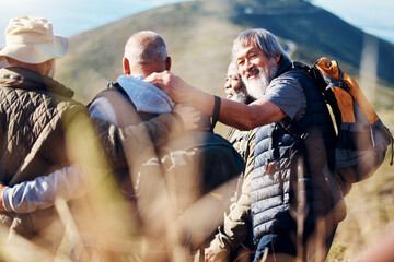 Senior hiking, mountain and elderly friends in nature on a walk with freedom and hug in retirement. Healthy exercise, trekking and and outdoor travel adventure of old men group together for walk