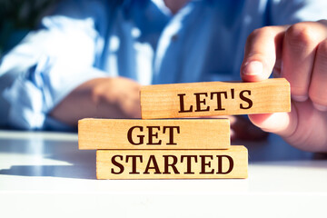 Wall Mural - wooden blocks with words 'let's get started'.