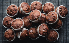Close Up Of  Many Chocolate Chip Zucchini Muffins On Black Background.