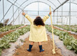 © D Lahoud/peopleimages.com - Child, girl or arms up in farming success, greenhouse harvest or agriculture land growth in sustainability field. Hands raised, winner or celebration for farmer kid, gardening tools or lettuce soil
