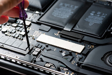 close up of technician repairing electronic circuit board, repairing, upgrade and technology.