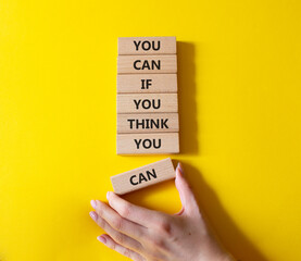 Wall Mural - Motivation symbol. Wooden blocks with words You can if You think You can. Businessman hand. Beautiful yellow background. Business and motivation concept. Copy space.