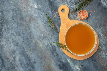 Canvas Print - bowl of fresh chicken broth in Bowl with meat pork knuckle. banner, menu, recipe place for text, top view