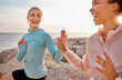© Lumeez/peopleimages.com - High five, spiritual and friends doing a meditation at the beach for health, mind and zen in Bali. Teamwork, laughing and women with hands for connection during an exercise for peace by the sea