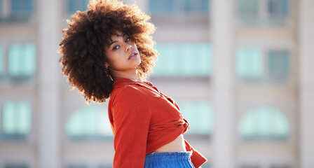 Street fashion, portrait of black woman with afro, urban gen z in trendy style and attitude in summer weekend. Beauty, city lifestyle and funky girl with serious face and hip hop streetwear in Brazil