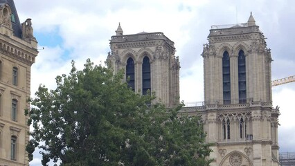 Wall Mural - Bell towers of Notre-Dame seen from a Bateau Mouche tour boat cruising on the Seine river in Paris, France