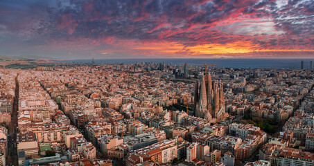 Fototapete - Aerial view of Barcelona City Skyline and Sagrada Familia Cathedral at sunset. Eixample residential famous urban grid. Cityscape with typical urban octagon blocks