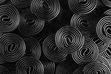 Stacks Of Circularly Rolled Black Liquorice. Illustration Of The Concept Of Herbalism And Medical Use Of Liquorice And As A Design Background For Web And Presentation