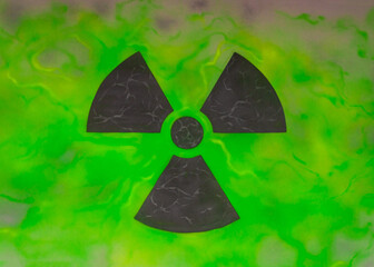 A sign of radioactive danger. A black emblem of radioactive hazard on a neon-green background. High quality photo