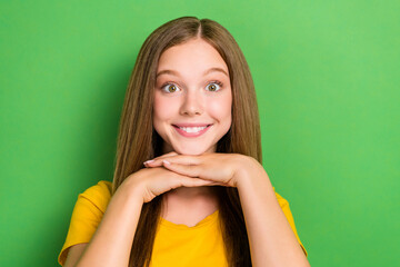 Sticker - Photo of cute smiling satisfied little lady teenager schoolgirl wear orange t-shirt hands together after dentistry isolated on green color background