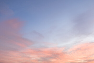 Wall Mural - Sky with soft and fluffy pastel pink and blue colored clouds. Sunset background. Nature. sunrise. Instagram toned style