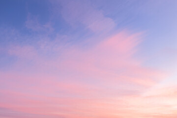 Wall Mural - Sky with soft and fluffy pastel pink and blue colored clouds. Sunset background. Nature. sunrise. Instagram toned style