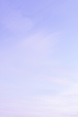 Wall Mural - Sky with soft and fluffy pastel lilac pink and blue colored clouds. Sunset background. Nature. sunrise. Instagram toned style. Vertical
