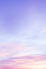Wall Mural - Sky with soft and fluffy pastel lilac pink and blue colored clouds. Sunset background. Nature. sunrise. Instagram toned style. Vertical