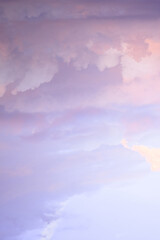 Wall Mural - Sky with soft and fluffy pastel pink and blue colored clouds. Sunset background. Nature. sunrise. Instagram toned style. Vertical